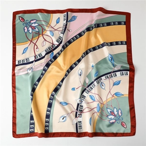 Close-up of the elegant calla lily floral pattern on a 90cm square satin silk scarf
