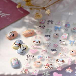 Cute puppy party nail stickers with bows and glitter finish on a white ceramic plate