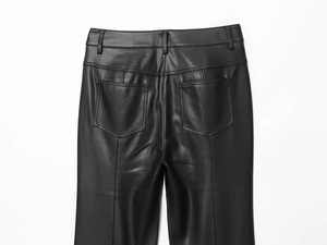 Close-up of back waist detail and rear pockets on black faux leather flare pants