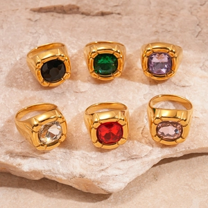 Chunky gold stainless steel rings with colorful square zircon stones on beige stone base