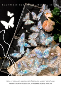 Laser butterfly PET stickers with holographic finish shown on vintage book pages and pearls