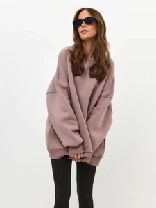 Detailed view of oversized mauve hoodie featuring thick fleece fabric and drop shoulders
