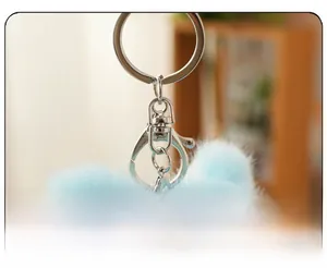 Detailed close-up of the premium silver metal clasp and ring on a soft plush keychain