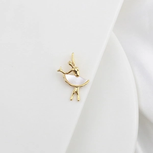 Detailed view of an 18k gold ballet dancer pendant with white mother-of-pearl skirt