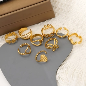 9-piece gold butterfly and heart ring set displayed on a heart-shaped tray
