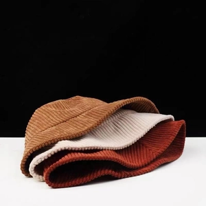 Stack of vintage corduroy bucket hats in brown, beige, and reddish-brown colors