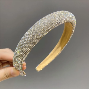 Close-up of sparkling rhinestone padded headband with beige velvet lining