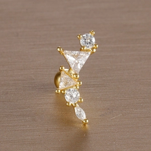 Macro shot of gold-plated leaf stud earring featuring marquise and round cubic zirconia