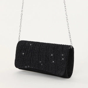 Close-up of black glitter evening bag with ruched texture and silver chain strap