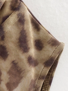 Close-up of leopard print mesh fabric detail with professional stitching and airy texture