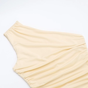Detailed view of the ruched asymmetric one-shoulder neckline on a cream party dress