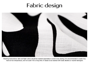 Close-up of black and white wavy pattern fabric with detailed woven texture and washing guide