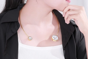 Detail of gold choker necklace with large clear cubic zirconia on neck model