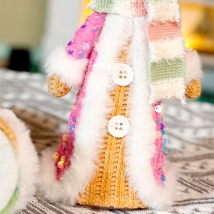 Pink knitted Christmas gingerbread man plush with sequins and fuzzy fur trim details
