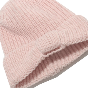 Close-up of pink knitted hat showing chunky textured stitching and warm folded brim design