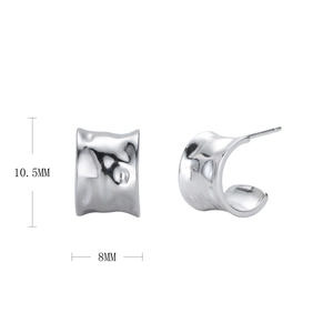 Macro detail of silver C-shape hammered earrings with 10.5mm height and 8mm width dimensions