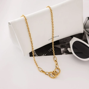 Detail of gold-plated stainless steel necklace with multi-layered interlocking circles