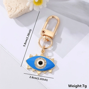 Detailed view of evil eye keychain with blue enamel, crystals and size dimensions