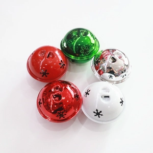 Detailed view of five multi-colored 5cm Christmas bells with snowflake cutout patterns