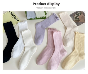 Detail of ruffled cuffs on vertical striped knit modal socks in macaron colors
