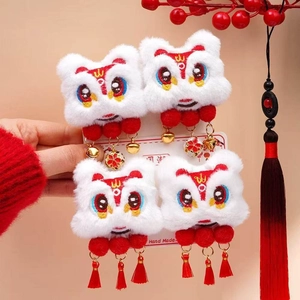 Detail of handmade lion dance hair clips with red tassels and golden bells for New Year