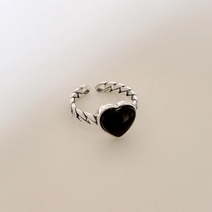 Detailed close-up of S925 sterling silver stamp on vintage heart ring with Cuban link band