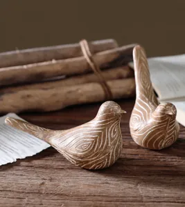 Close-up of bird resin sculptures with wood grain texture for home decor