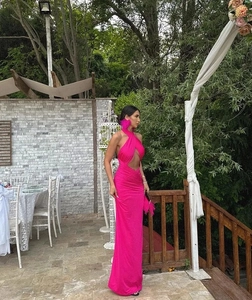 Detail of elegant pink halter neck maxi dress with draped fabric and floor-length design
