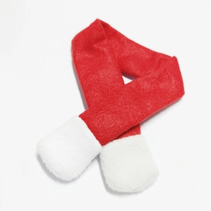 Close-up of a mini red Christmas scarf with white plush trim for wine bottle decor