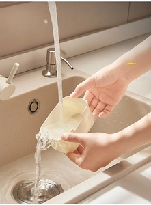 Detail of detachable food-grade relish box inner compartment being washed under water