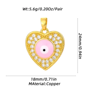 Golden heart pendant with pink evil eye and crystals, dimensions 24mm by 18mm copper