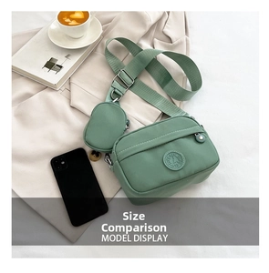 Sage green nylon shoulder bag with removable coin purse and smartphone size comparison