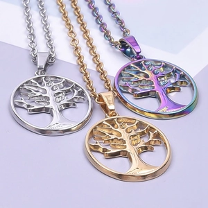 Detailed view of three stainless steel tree of life pendants in silver, gold and rainbow