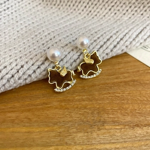 Detail of vintage rocking horse earrings with brown flocking, pearls and small diamonds