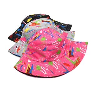 Three-pack of graffiti bucket hats in pink, grey, and black with retro 90s geometric patterns