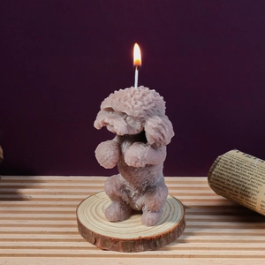 Detail of lavender poodle wax candle showing intricate lifelike fur texture and lit wick