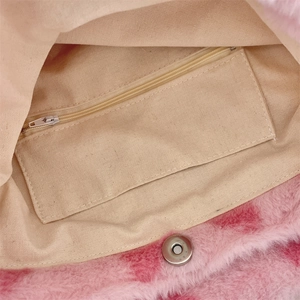 Detail of plush leopard print bucket bag featuring canvas lining and interior zipper pocket