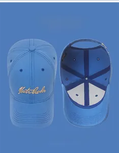 Detailed view of blue cotton baseball cap with gold embroidery and internal lining structure