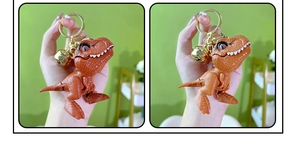 Detail view of T-rex keychain with realistic skin texture, golden bell, and key ring