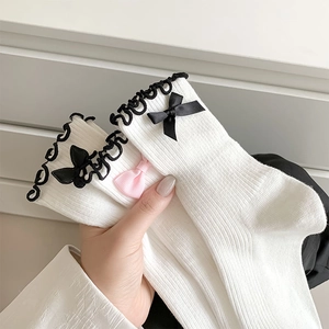 Detail of white ribbed JK socks featuring black wavy lace and cute bowknot decorations
