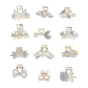 Set of 12 gold metal mini hair claws with rhinestones and bows in 4x3 array