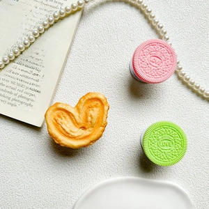 Detailed view of pink and green LOVE embossed biscuit phone grips with heart-shaped pastry