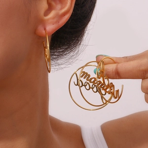 Detail of 18K gold-plated stainless steel hoop earrings with Mama and Mood lettering