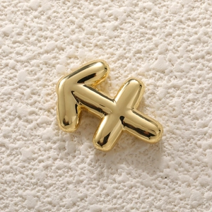 Macro shot of 18K gold-plated Sagittarius zodiac bubble pendant with metallic texture