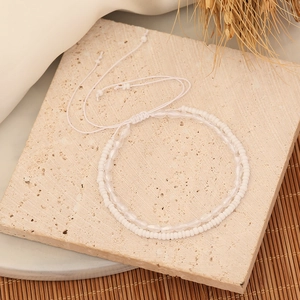 Detail of double-layer beaded bracelet with white and clear crystal glass beads