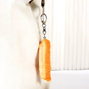 Realistic fried chicken nugget keychain with crispy texture on a white canvas bag