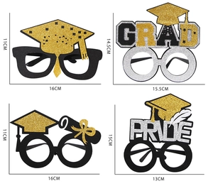Detail view of four glitter graduation party glasses with Grad and Pride text designs