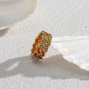 Bohemian gold Cuban chain ring featuring multicolored zircon stones on white shell background