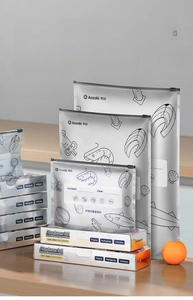 Three sizes of aluminum foil food storage bags with sliding zippers and date labels