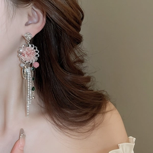 Elegant pink flower tassel earrings with crystals and pearls on model profile